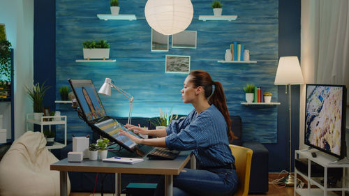 Portrait of woman using laptop on table