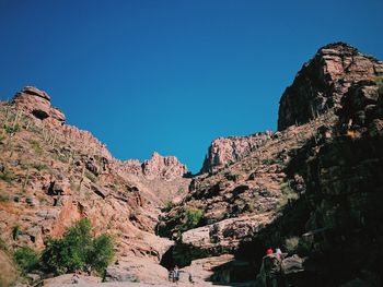 Scenic view of rocky mountains against clear blue sky