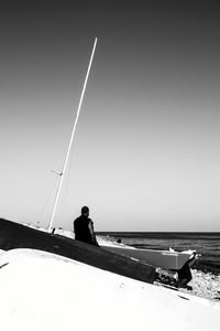 Man on boat at beach against sky