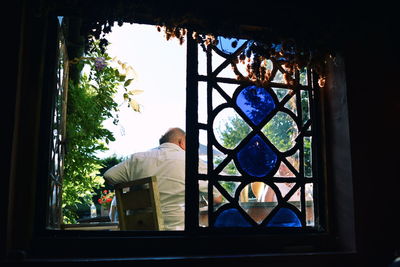 Man seen through window