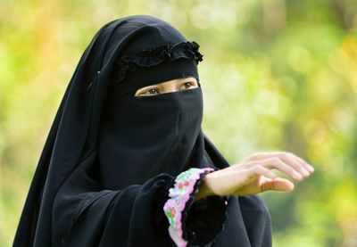 Midsection of person wearing black hat outdoors