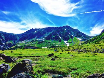 Scenic view of mountains against cloudy sky