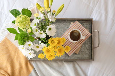 High angle view of yellow flower vase on table