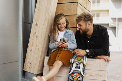 Father with daughter looking at cell phone