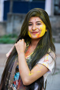 Close-up portrait of smiling young woman