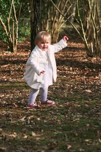 Full length of cute girl on field