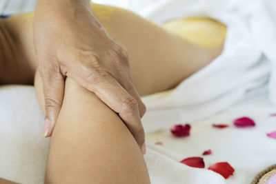 Midsection of woman lying on bed