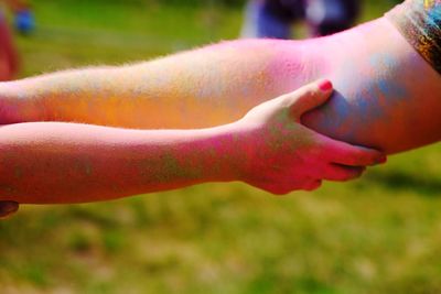 Close-up of hands on field