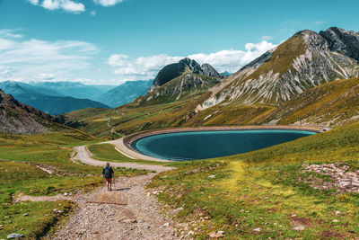 Backpacker on hiking trails in the dolomites, italy.