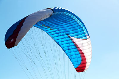 Low angle view of flag against clear blue sky