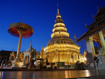 Low angle view of illuminated buildings against sky