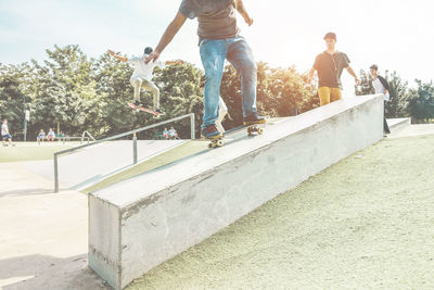 Low section of man skateboarding against sky