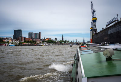 Panoramic view of sea and buildings against sky