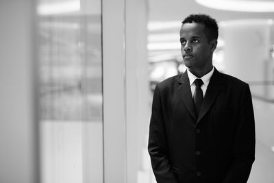 Portrait of young man standing at home