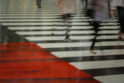 Low section of people walking on road