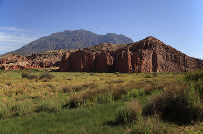 Scenic view of mountains against clear blue sky