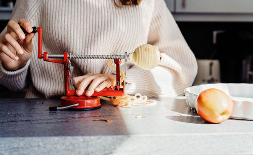 Midsection of woman preparing food in kitchen