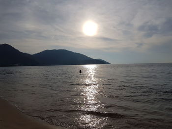 Scenic view of sea and mountains during sunset