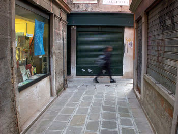 Man walking on corridor of building