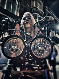 Low angle view of woman on motorcycle