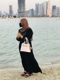 Rear view of woman standing on beach