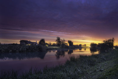 Scenic view of lake against sky during sunset