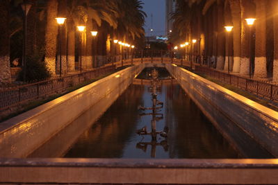 View of canal in city at night