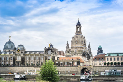 Low angle view of cathedral against cloudy sky in city