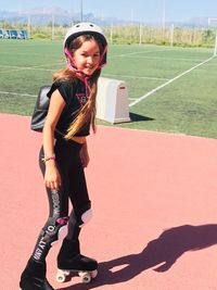 Full length portrait of girl roller skating on footpath