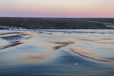 Scenic view of sea against clear sky during sunset