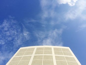 Low angle view of modern building against blue sky