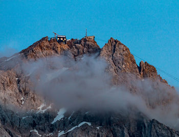 Panoramic view of snowcapped mountains against clear blue sky