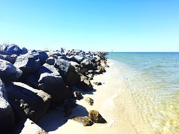 Scenic view of sea against clear blue sky