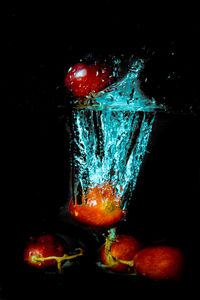 Close-up of water drops on glass against black background