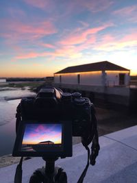 Man photographing at sunset