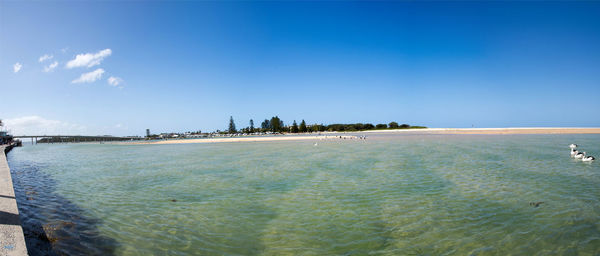 Scenic view of sea against blue sky