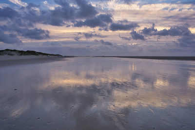 Scenic view of beach against sky during sunset