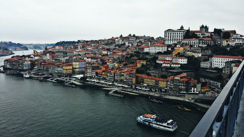 River by buildings against sky