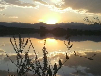 Scenic view of lake at sunset