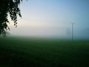 Scenic view of field against cloudy sky