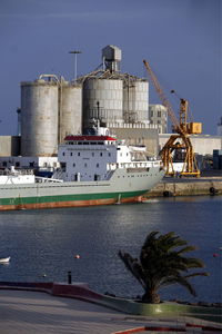 Container ship on sea by factory