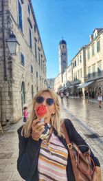 Portrait of young woman looking away in city