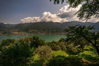 Scenic view of lake and mountains against sky