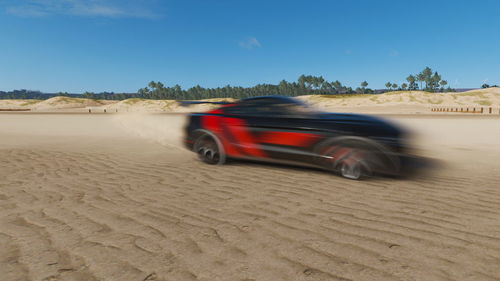 Blurred motion of car on desert land