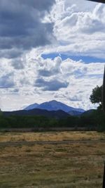 Scenic view of landscape against cloudy sky