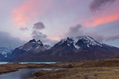 Scenic view of snowcapped mountains against sky during sunset