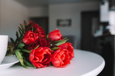 Close-up of red roses on table