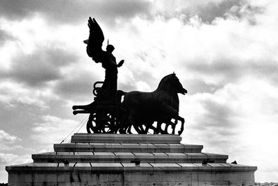 Low angle view of statue against cloudy sky