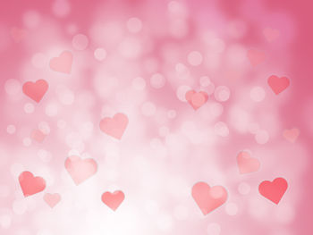 Defocused image of heart shape pink balloons
