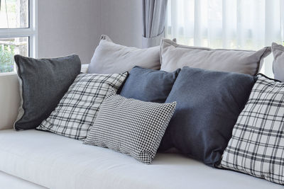 Midsection of woman relaxing on sofa at home